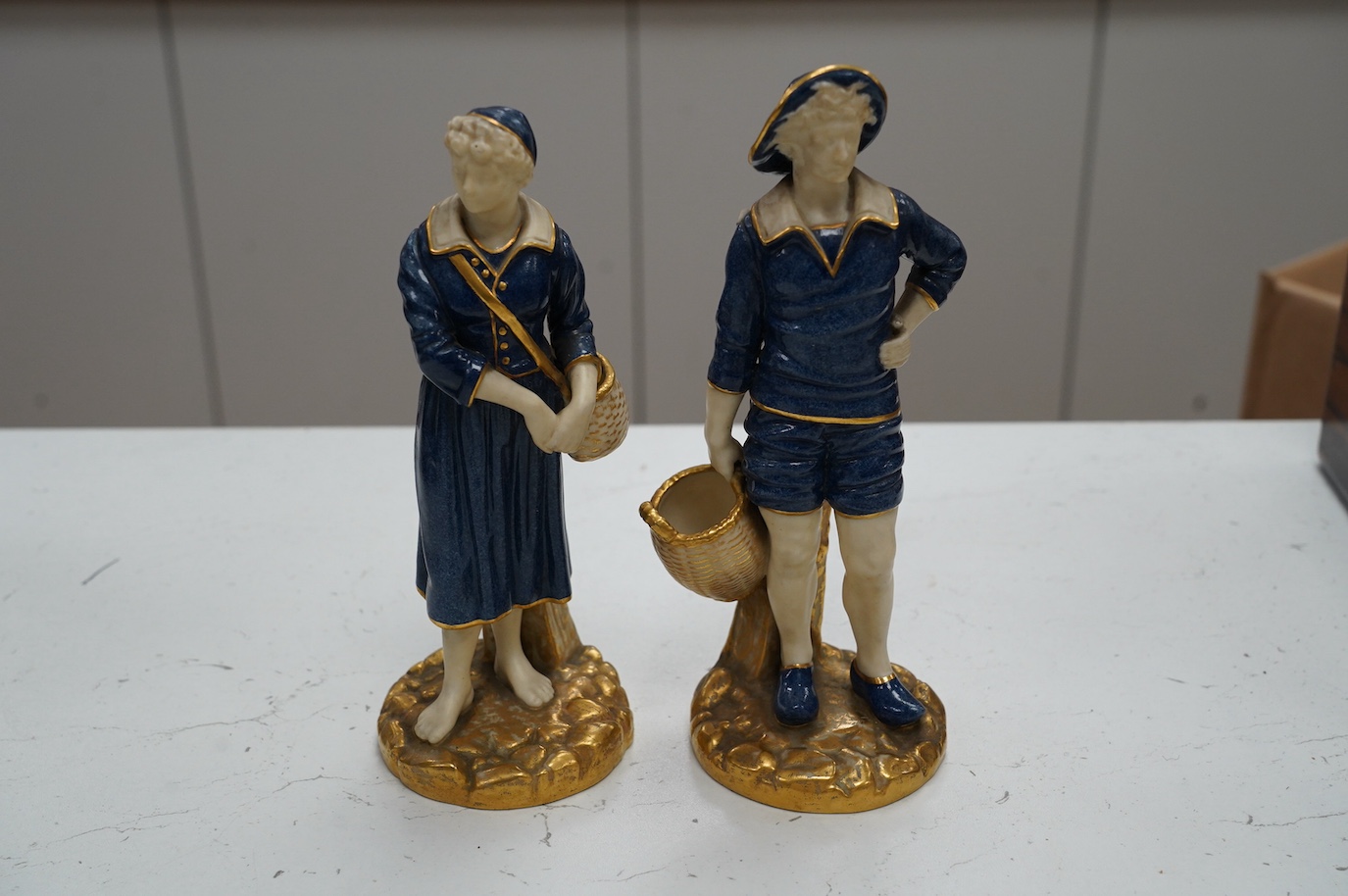 A pair of Worcester figures, fisherfolk, model number 1202, 21cm. Condition - good, some minor wear to gilding